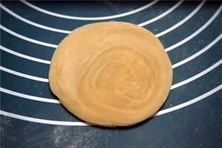 取一块静置的面团擀开。