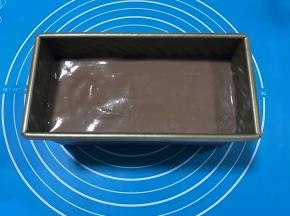 此时吐司已经发到2倍大，将可可蛋糕液倒入吐司模具中，轻震2下，震出里面的大气泡。放入预热好的烤箱中，170度，上下火，35分钟左右即可。烤15分钟的时候在蛋糕表面划上一刀，撒上杏仁片。