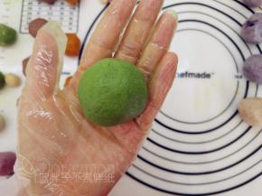 一手大拇指按住馅料，另一手虎口往上推饼皮，使它紧贴着馅料并慢慢地往上爬，最后收口，并将其滚圆。