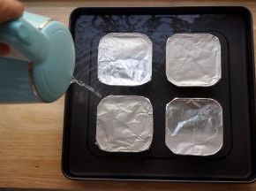 分别封上锡纸，并且往烤盘里注入沸水，液面最好可以浸泡到碗里的奶面位置。