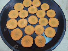 盘中放入切成薄片的胡萝卜垫底防粘