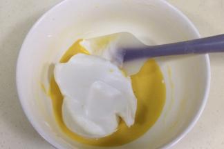 取1/3蛋白糊加入蛋黄液中，用刮刀翻拌均匀。