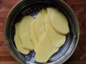 将土豆片放入微波炉蒸盒中