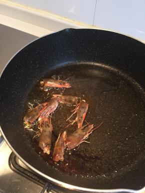 热锅冷油下虾头炼油，当锅内油呈金黄色后，弃虾头