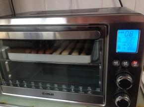 在温暖处发酵30分钟，在表面喷一点水，选择东菱烤箱08键（默认上火220度，下火200度），烘烤12分钟