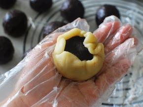 然后将面团压薄，包裹住馅料，收口捏紧。