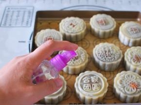 烤箱上下火180度预热。月饼入炉烘烤前先喷点水（不要直接对着喷，离远点喷，让水雾沾上去即可）。