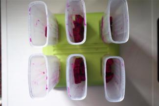 将果肉平均分配到6个冰棒模具中。