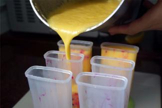 然后倒入哈密瓜椰奶混合物，插入冰棒棍子，放入冰箱冷冻4小时以上。