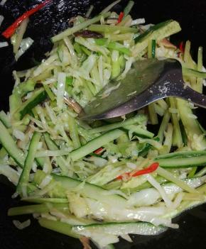 锅里重新加油，放冬菇翻炒半分钟，加入包菜，芹菜继续炒到断生，加入青瓜翻炒均匀，加入底盐，铲出备用。
