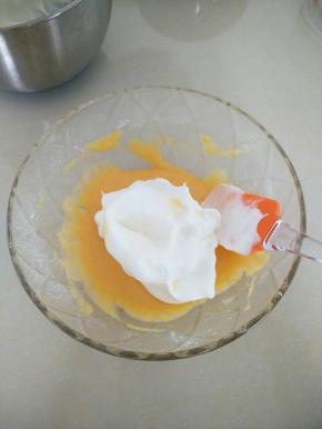 把蛋黄碗中，加入一半打好的蛋白，用刮刀上下拌匀。