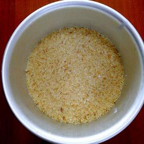 黄油隔水融化，加入饼干碎中搅拌均匀，倒入蛋糕模具中，放入冰箱冷藏