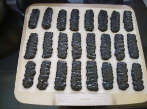  烤盘上垫油纸，将面糊放入裱花袋，挤成长约7厘米宽约3厘米的面糊。