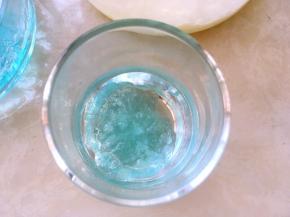 用勺舀一部分鸡尾酒冻倒入玻璃杯内，再舀一部分牛奶冻倒入玻璃杯内，让鸡尾酒跟牛奶间隔开，分出层次