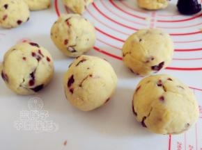 取一个绿豆泥，滚圆之后压扁，包入红豆沙，再滚圆。手法和包月饼一样。