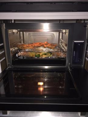 再将鸡腿翻面放到烤架上，土豆、青椒、洋葱放入烤盘上，表面撒上椒盐、黑胡椒碎