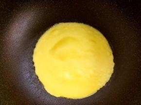 平底锅小火加热，舀一勺面糊倒入锅内，晃动锅让面糊滚圆