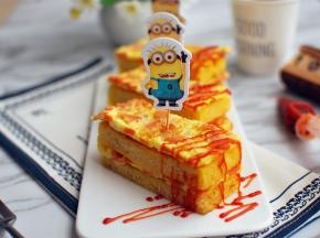 一层吐司片一层火腿煎蛋叠上去，两片吐司片两片火腿蛋一共叠4层。然后切成3份，淋上少许番茄酱，完成。