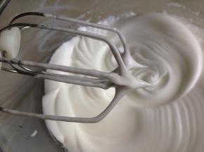 将45克糖分三次加入到蛋清里，将蛋白打至短小的尖角