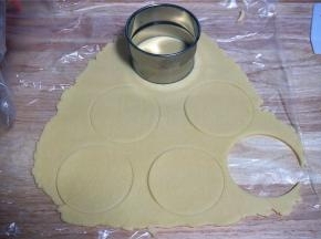 用一个比六连杯模具上口直径大3厘米的圆形饼干模具印出6片大圆面片。（没有模具的可以取一小块面团，捏成圆形薄片即可）