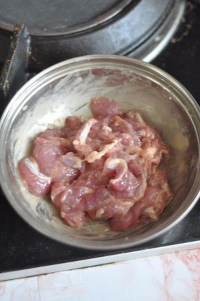 猪肉切片，加入蛋液、淀粉、鸡粉腌制片刻。