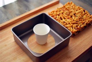 冷却后用杯子托起模具底部，轻压一下模具便可脱模。