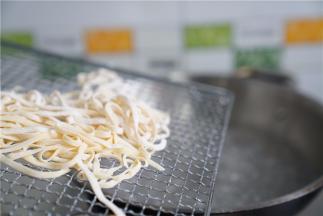 锅里加水煮开，将压制好的面条入锅。