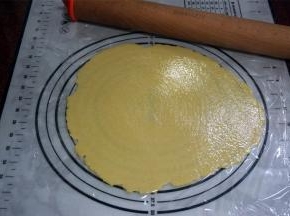 接着用擀面杖将面团擀成3毫米厚的圆片，尽量擀圆。