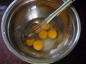 将蛋黄，玉米油，清水，盐，20克细砂糖同放入打蛋盆中，拌均匀。