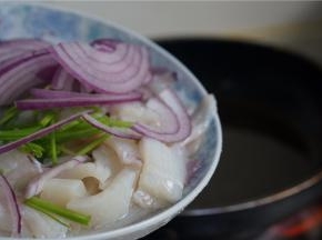 取少许原汤煮开，下墨鱼洋葱及葱段。
