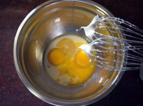 制作面糊：蛋黄中加入13克细砂糖，20克纯牛奶或清水，33克玉米油，拌至糖融化。