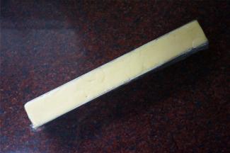 饼干模具铺上一层保鲜膜，然后填入面团，压整齐。放入冰箱冷冻1小时左右使面团变硬。