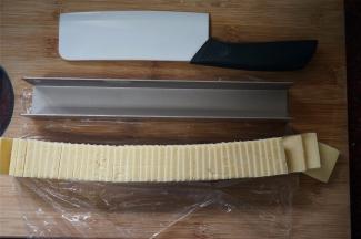 取出冷冻好的面团，脱模，切成0.6厘米厚的面片。尽量切得厚薄均匀哦！