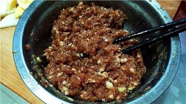 猪肉馅中加入料酒、油、盐、胡椒粉、葱姜，搅拌均匀上劲。