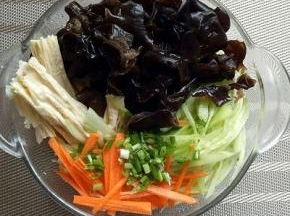 黄瓜和胡萝卜切丝。几种食材放在容器里。