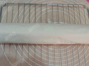 然后用擀面杖辅助，用另一张油纸卷起来，冷却定型后切成段