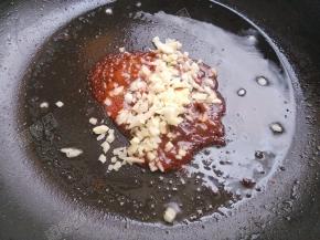 锅中另加油烧热，放入豆瓣酱，加入姜蒜末小火炒出红油