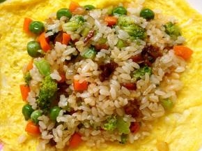 鸡蛋饼倒扣在盘子内，加入适量的炒饭