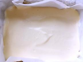 模具铺油纸，倒入一半搅拌好的面糊，用刮刀刮平正