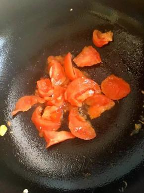 6、	用锅中的余油倒入西红柿翻炒