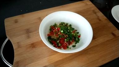 空碗中放入大蒜末，青红椒，一半的葱花