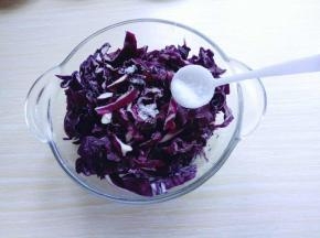 将洗干净的紫甘蓝放入玻璃器具中，加入盐。