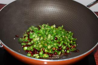 热锅，倒油，放入干辣椒、青辣椒，爆炒；