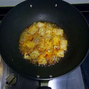 将豆腐放入锅中翻炒均匀，加入适量清水，小火煮片刻