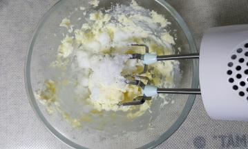 在打发后的黄油中加入白砂糖，用电动打蛋器搅打均匀