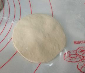 取一剂子，按扁，擀成中间厚，四边薄的圆形面片；