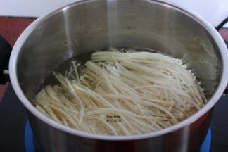 清水煮饭，放入金针菇汆汤熟；