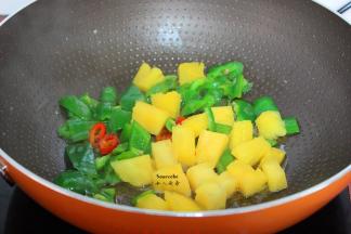 放切好的红辣椒、青辣椒、煸香，再放入菠萝块；