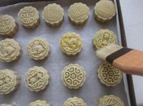 烤箱200度预热5分钟，把月饼放入改190度烤5分钟定型，拿出刷上薄薄的一层蛋黄液（蛋黄液是按照一个蛋黄加上一点点清水拌匀）。