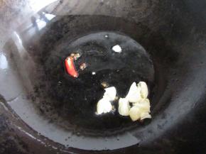 把锅里放油，下辣椒和蒜蓉煸炒。